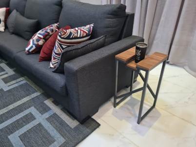 A couch with pillows on it

Description automatically generated